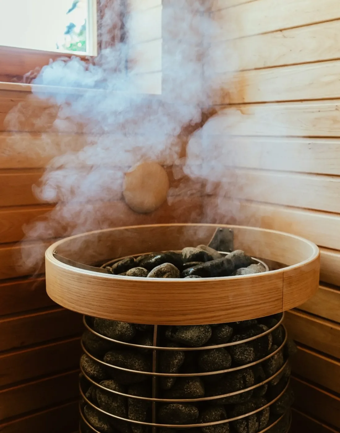 Steam rising from sauna stones inside Fox Recovery Studio